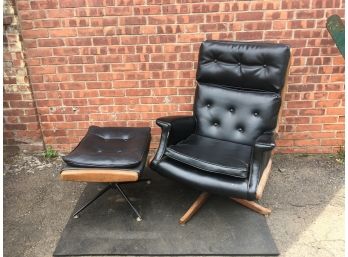 Black Cushioned Chair With Foot Rest