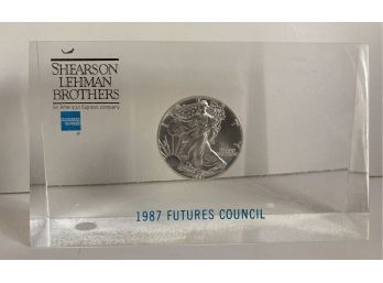 1987 Silver Dollar Encased In Lucite From Shearson Lehman Bros