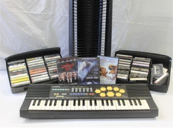 Vintage Electronics Lot Including Casio Key Board, Cassettes, DVD's & DVD Holder