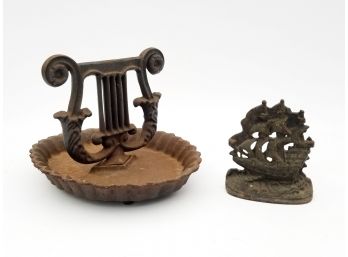 A Rustic Iron Bootscape And Doorstop