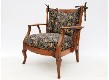 A Vintage Maple Arm Chair With Elephant Themed Upholstery