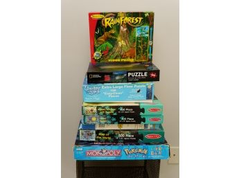 Collection Of Jigsaw Puzzles And Pokémon Monopoly