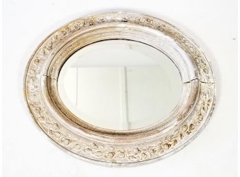 An Antique Oval Framed Mirror