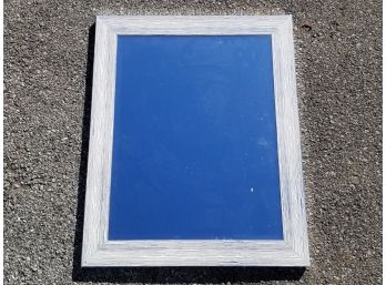 A Bright, Silver And White Framed Mirror