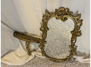 Vintage Mirror That Sits On A Matching Wall Ledge