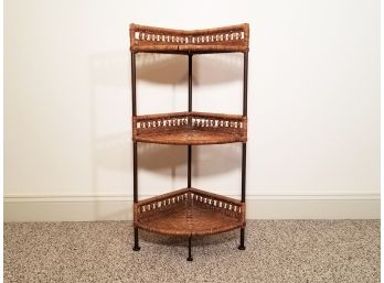 A Metal And Wicker Corner Shelf