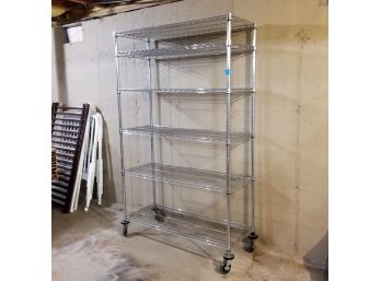 A Large Metal Shelf On Casters