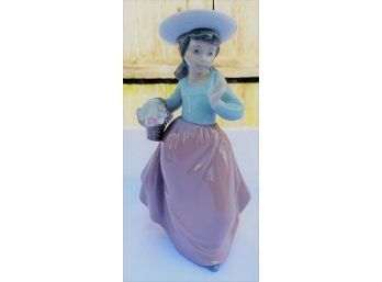 NAO Porcelain Figurine Of A Lovely Young Girl In A Hat With A Basket Of Flowers