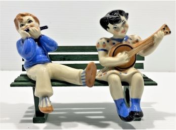 Cute Pair Of Vintage Ceramic Figurines Sitting On Wooden Bench Playing Music