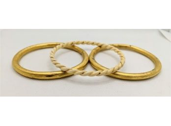 2 Heavy Gold Bangles And One Light Faux Ivory And Gold Braided Bangle