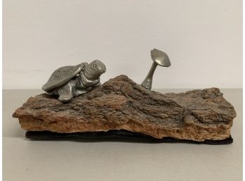 Silver Turtle And Mushroom On A Log