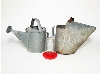 Galvanized Steel Watering Cans And A Chicken Feeder