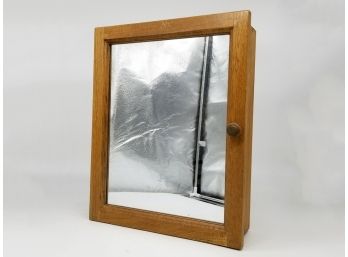 A Vintage Oak Medicine Cabinet With Inset Mirrored Panel