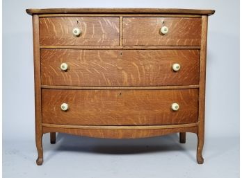 An Antique Oak Bow Front Chest Of Drawers