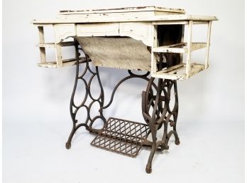 A White Painted Antique Sewing Machine Table On Cast Iron Base