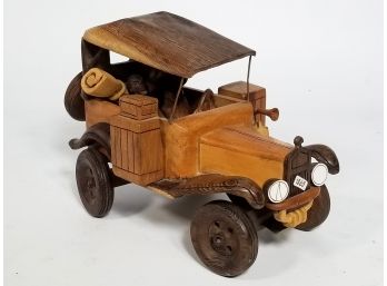 A Wood Carving Of A Vintage Car