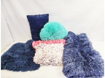 Grouping Of Colorful Fuzzy Throw Pillows And Blue Shag Small Area Rug