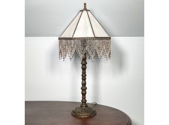 A Vintage Stick Lamp With Slag Glass And Beaded Shade