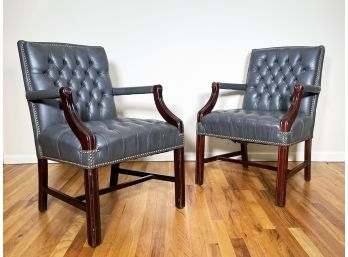 A Pair Of Leather Arm Chairs With Brass Nailhead Trim