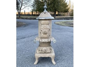 An Antique Century Oak Cast Iron Stove