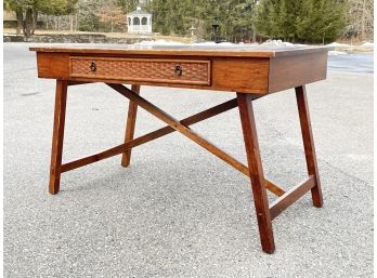 A Rattan And Wood Trestle Desk