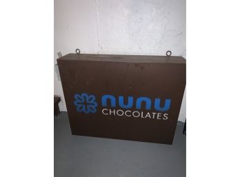 NYCs NUNU Chocolates Electrified Swinging Sign