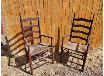 Two Antique Rush Seat Ladderback Arm Dining Chairs