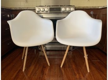 2 White Plastic Chairs With Wooden Legs