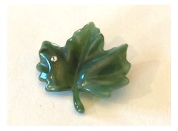 Green Hard Plastic Maple Leaf Pin With A Single Rhinestone