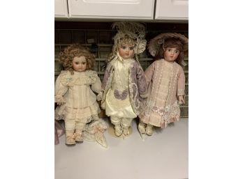 3 Porcelain Girl Dolls With Intricately Designed Sewn Dresses