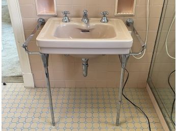 A Vintage Ceramic Sink With Chrome Fittings, Legs, And Towel Bars