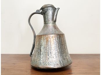 A Polished Antique Hammered Copper Pitcher