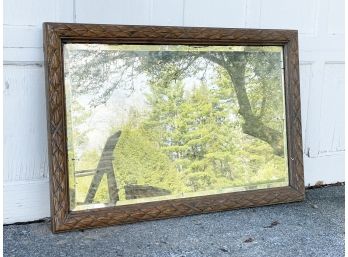 A Large Vintage Carved Oak Beveled Mirror