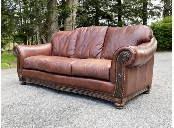 A Sofa In Chestnut Leather With Nailhead Trim