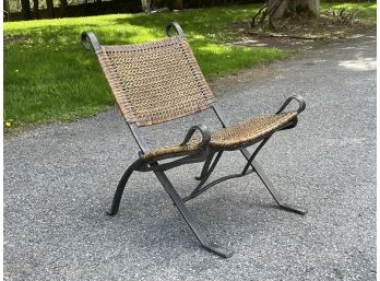 A Wicker And Iron Folding Chair