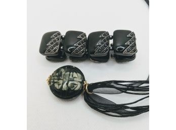 Unique Pendant Necklace Paired With A Black Chunky Bracelet