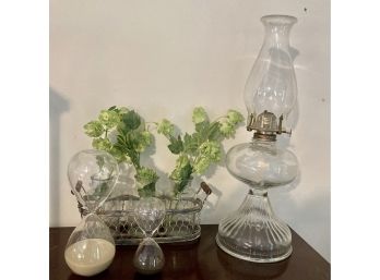 Hurricane Lamp, Glass Sand Timers And Foliage In Jars