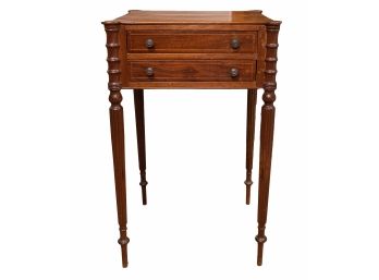 Sheraton Style Mahogany Tone End Table With Two Banded Drawers, Brass Tone Drawer Pulls And Turned Reeded Legs