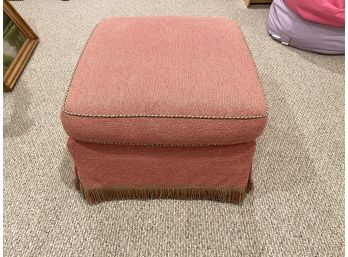 Upholstered Ottoman In Quality Salmon Colored Fabric With Highly Detailed Fringe And Contrast Welting