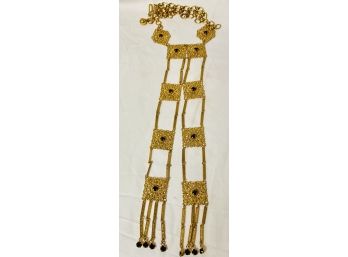 Neck Lace In Gold Tone Metal With A Very Long Hanging Design With Black Beads