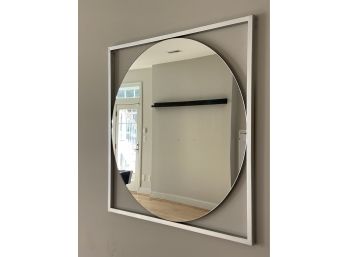 A Contemporary Round Mirror In An Open Metal Frame