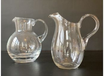 A Pair Of Clear Glass Pitchers