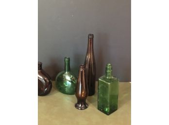 Five Green And Amber Glass Bottles