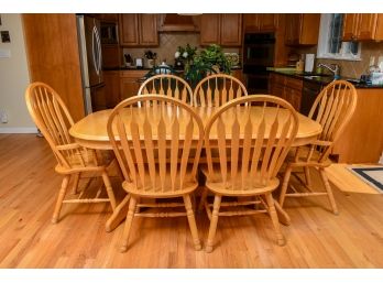 Oak Dining Table With Interior Extendable Leaves And Six Windsor Style Chairs