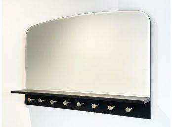 A Modern Beveled Mirror With Hooks Below