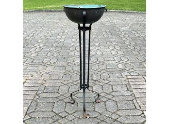 A Copper Cache Pot On Wrought Iron Base