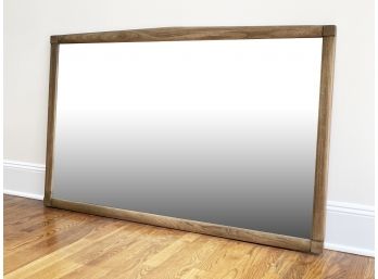 A Large Mirror In Blonde Oak