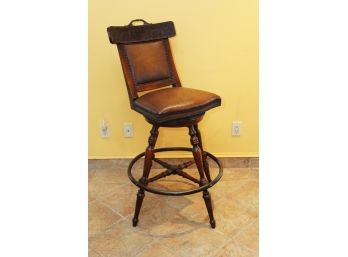 A Bar Stool With Brass Rail With Leather Upholstery By Theodore Alexander