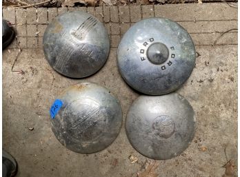 FOUR ANTIQUE HUB CAPS