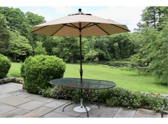 Wrought Iron Oval Table And Wind Up Patio Umbrella With Cast Iron Stand